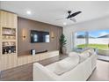 Modern living room featuring a stylish accent wall, sleek lighting, and comfortable seating at 207 Polermo Ave, St Cloud, FL 34771