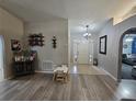 Inviting entryway featuring hardwood floors and modern decor leading to the living areas at 2413 Sandridge Cir, Eustis, FL 32726