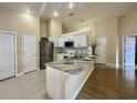 Bright kitchen featuring stainless steel appliances, granite counters, and ample cabinet space at 304 N Hastings St, Orlando, FL 32835