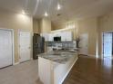 Modern kitchen featuring stainless steel appliances, granite counters, and ample cabinet space at 304 N Hastings St, Orlando, FL 32835