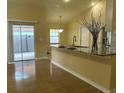 Bright kitchen featuring granite counters, a breakfast bar, and views of the patio at 304 N Hastings St, Orlando, FL 32835