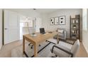 Bright home office with modern furnishings and a view into the kitchen at 3415 Sagebrush St, Harmony, FL 34773