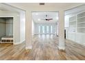 Spacious living room features hardwood floors, a modern ceiling fan, and natural light from the rear exterior doors at 418 Norwood Ct, Oviedo, FL 32765