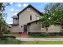 Inviting two-story home featuring neutral siding, brick accents, and a well-manicured lawn at 421 Broadway Ave, Orlando, FL 32803