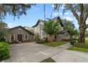 Charming two-story home with a detached garage and lovely landscaping around the house and mature trees at 421 Broadway Ave, Orlando, FL 32803