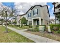 A row of townhomes with manicured lawns and sidewalks at 5025 Walker St, St Cloud, FL 34771