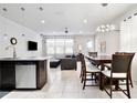 Bright living and dining area with tile flooring, modern lighting fixtures, and open concept design at 5025 Walker St, St Cloud, FL 34771