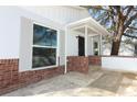 The exterior features a brick wall accent, grey trim, modern windows, and a covered front porch at 6222 Fox Hunt Trl, Orlando, FL 32808