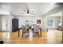 Bright dining room with wood floors, ceiling fan, and natural light, ideal for Gathering gatherings at 6762 Tamarind Cir, Orlando, FL 32819