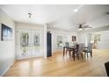 Open-concept dining room with hardwood floors, bright windows, and an adjacent living space at 6762 Tamarind Cir, Orlando, FL 32819