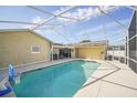 Screened-in pool with blue water and plenty of space for outdoor entertaining on a sunny day at 6762 Tamarind Cir, Orlando, FL 32819