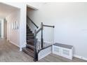 Welcoming foyer features wood stairs, elegant railings, and stylish storage bench, creating a warm ambiance at 793 Hyperion Dr, Debary, FL 32713