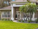 Close up view of the beautifully landscaped front entrance with a walkway and garden beds at 806 Roswell Cv, Lake Mary, FL 32746