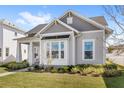 Stylish single-Gathering home showcasing a lush green lawn and gray wood facade at 936 Allendale Ln, Winter Garden, FL 34787