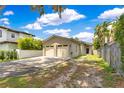 A single story home with a two car garage, a paved driveway and well kept landscaping at 1213 Richmond Rd, Winter Park, FL 32789