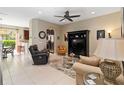 Comfortable living room with neutral tones, tile flooring, and an open layout to the kitchen at 124 Canterbury Bell Dr, Oviedo, FL 32765