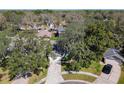 Aerial view of a charming home surrounded by mature trees and lush landscaping in a residential neighborhood at 1525 Oakwood Ct, Apopka, FL 32703