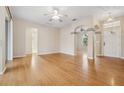 Spacious living room featuring gleaming hardwood floors, neutral walls, and an open floor plan at 1601 Stoneywood Way, Apopka, FL 32712