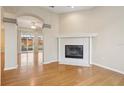 Bright living room featuring a fireplace and beautiful flooring, with access to the backyard at 1601 Stoneywood Way, Apopka, FL 32712