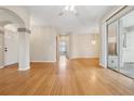 Bright and airy living room showcasing gleaming hardwood floors and an open floor plan at 1601 Stoneywood Way, Apopka, FL 32712