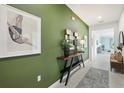 Inviting hallway featuring artwork, a console table, and stylish decor, leading to a bright, open living space at 1670 Blue Lagoon Cir, Mascotte, FL 34753