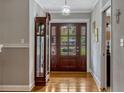 Inviting entryway featuring hardwood floors and a beautiful, large, wooden front door at 1800 Wycliff Dr, Orlando, FL 32803