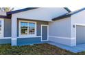 Charming single-story home featuring light gray stucco and a side entrance at 1857 Manitoba Ct, Poinciana, FL 34759