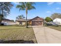 Inviting single-Gathering home featuring a spacious driveway and lush front yard at 288 Garland, Deltona, FL 32725