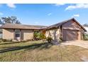 Well-maintained single-Gathering home featuring a lush front yard with manicured landscaping at 288 Garland, Deltona, FL 32725