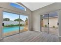 Bright living room with sliding glass doors leading to the pool and modern gray floors at 3288 Brewster Dr, Kissimmee, FL 34743