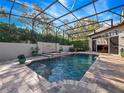 Sparkling in-ground pool features a waterfall feature, raised spa, and a screened enclosure at 3369 Park Grove Ct, Longwood, FL 32779