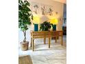 Foyer with rattan table, lamps, houseplant and marble flooring at 402 Cypress Dr # 402, Haines City, FL 33844