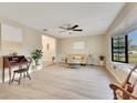 Bright living room boasts wood floors, a ceiling fan, and a bay window that floods the space with natural light at 4029 Cool Water Ct, Winter Park, FL 32792