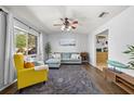 Bright and inviting living room with ample natural light and modern furnishings with hardwood style floors at 6872 Compass Ct, Orlando, FL 32810