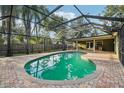 Beautiful screened-in pool with brick pavers and lush landscaping, perfect for relaxation and entertainment at 101 Ludlow Dr, Longwood, FL 32779