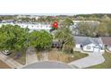 An aerial view of a well-situated home and neighborhood with mature trees near shopping and businesses at 102 Spanish Moss Ct, Orlando, FL 32828