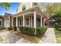 Inviting front porch with classic columns, manicured shrubs, and a charming walkway at 102 Spanish Moss Ct, Orlando, FL 32828