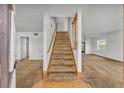 Inviting entryway with a carpeted staircase leading to the second floor and adjacent living area at 124 Cinnamon Dr, Orlando, FL 32825