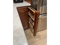 Kitchen cabinet pull-out with shelving for organized storage, perfect for spices and cooking essentials at 13245 Sw 85Th Pl, Dunnellon, FL 34432