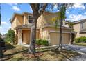 Two-story home featuring an attached two-car garage, well-maintained lawn and simple landscaping at 176 Blue Jay Way, Davenport, FL 33896