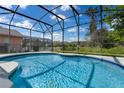 Relaxing screened-in pool with a sunny outdoor area perfect for entertaining and lounging at 176 Blue Jay Way, Davenport, FL 33896