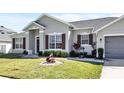 Charming single-story home features a manicured lawn and welcoming front entrance with decorative accents at 2168 Continental St, St Cloud, FL 34769