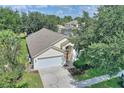 Aerial view of a single-story home, showcasing its well-maintained landscaping and neighborhood at 2676 Emerald Island Blvd, Kissimmee, FL 34747