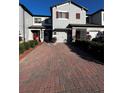 Townhouse featuring a brick-paved driveway and a cozy front garden at 272 Cedar Bark Ln, Sanford, FL 32771