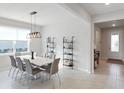 Dining room with white table, stylish chairs, modern lighting and decorative shelving at 2729 Timbergrove St, St Cloud, FL 34771