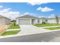 Inviting single-story home with a well-kept lawn, complemented by a two-car garage and neutral palette at 304 Towns Cir, Haines City, FL 33844