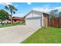 Lovely one-story house with a two-car garage, a concrete driveway, and a neat front yard at 3175 Arrowhead Ln, Kissimmee, FL 34746