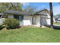 Quaint one-story home boasting a lush green lawn and a convenient two-car attached garage at 3455 Jujube Dr, Orlando, FL 32810