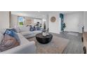Spacious living room features an open concept with blue accent wall and modern decor at 3489 Salvia Ct, Tavares, FL 32778
