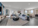 Open-concept living room featuring a large sectional sofa and lots of natural light at 3489 Salvia Ct, Tavares, FL 32778